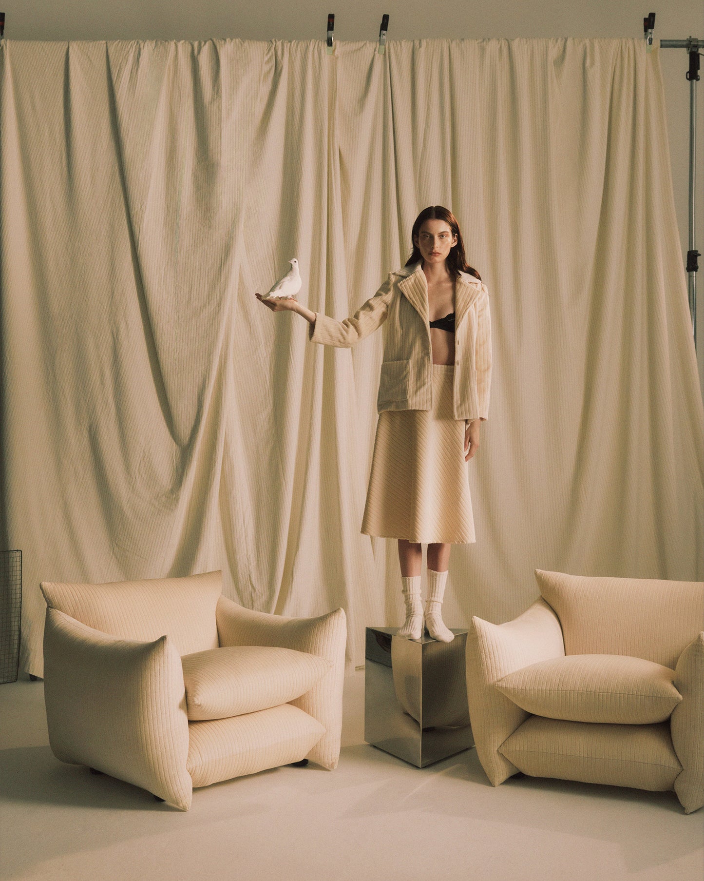 Small Prism Table with no top between two Studio Chairs in Milk Jumbo Cord