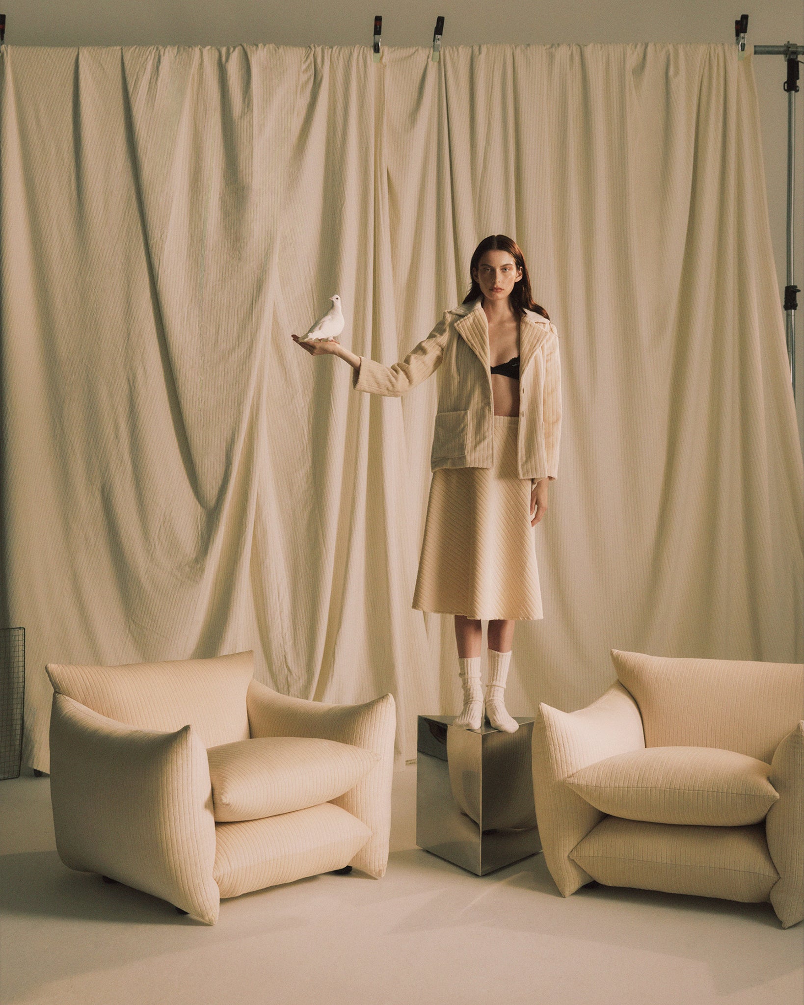 Small Prism Table with no top between two Studio Chairs in Milk Jumbo Cord